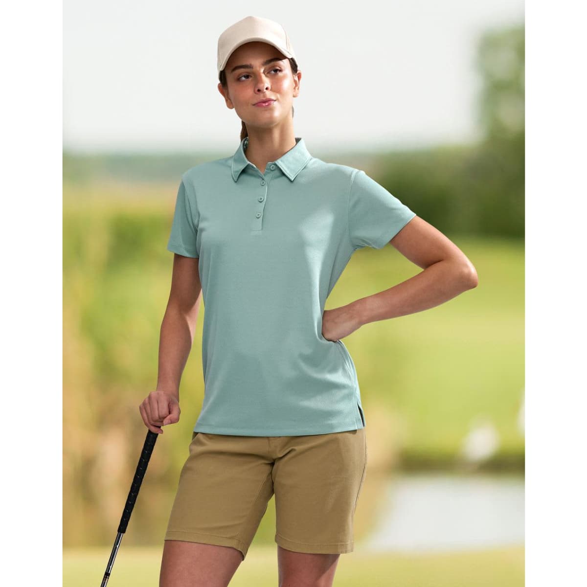 A teal ladies' sustainable jacquard knit short sleeve polo with a collar and side split. It has a logo on it.