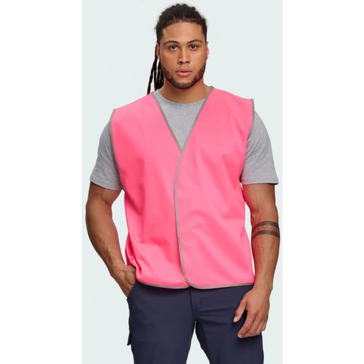 A Hi-Vis safety vest in bright yellow, featuring reflective trim, worn by a man in a collared shirt and tie.