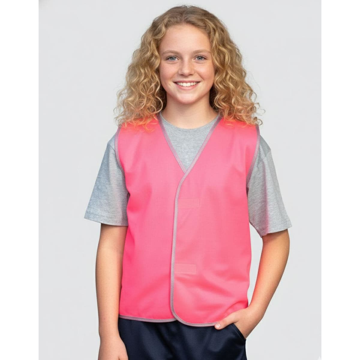 A bright orange children's safety vest with grey trim, suitable for uniform use. The vest has a simple design and no logos.