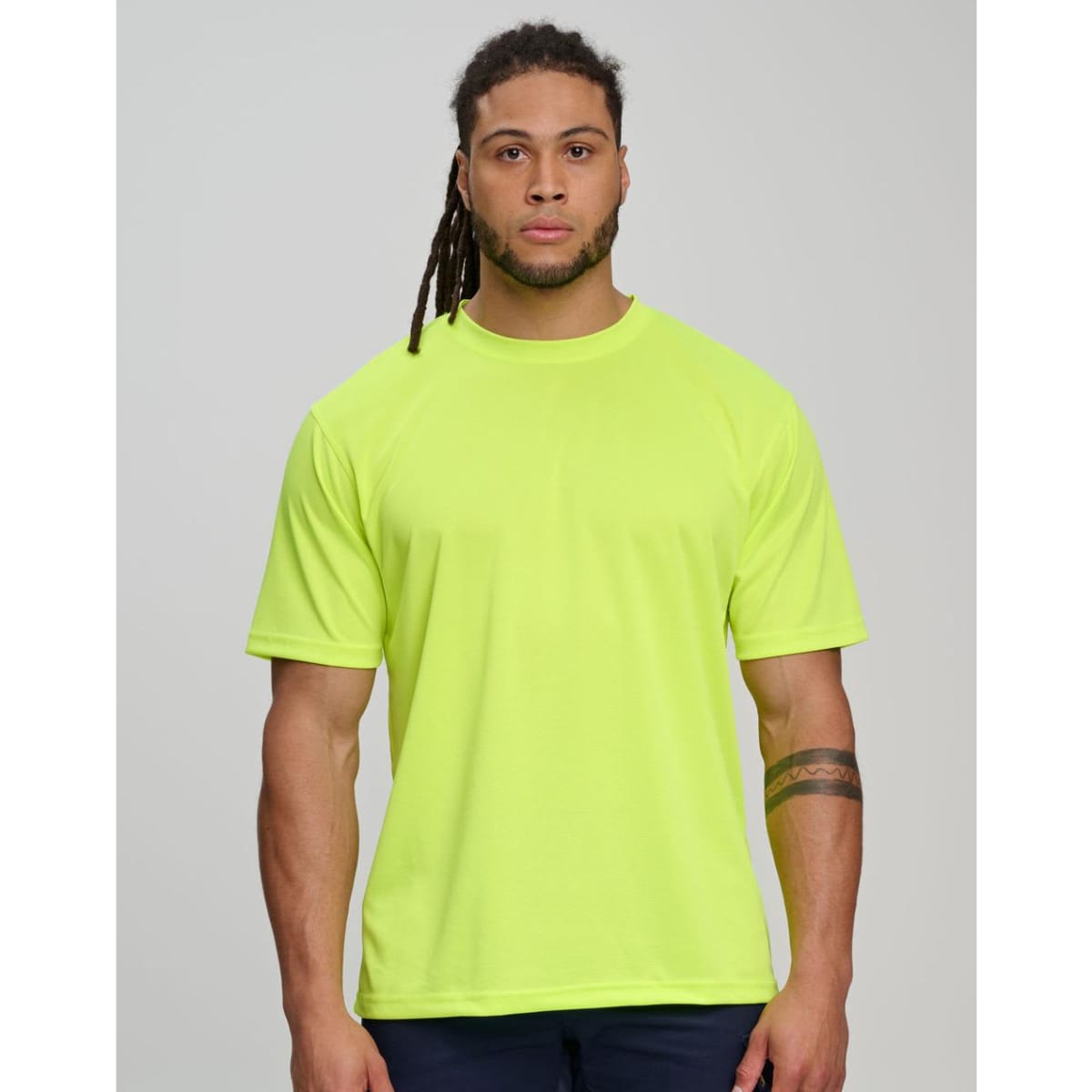 A hi-vis mini waffle safety tee in bright orange worn by two people in a workshop setting. Features a logo.