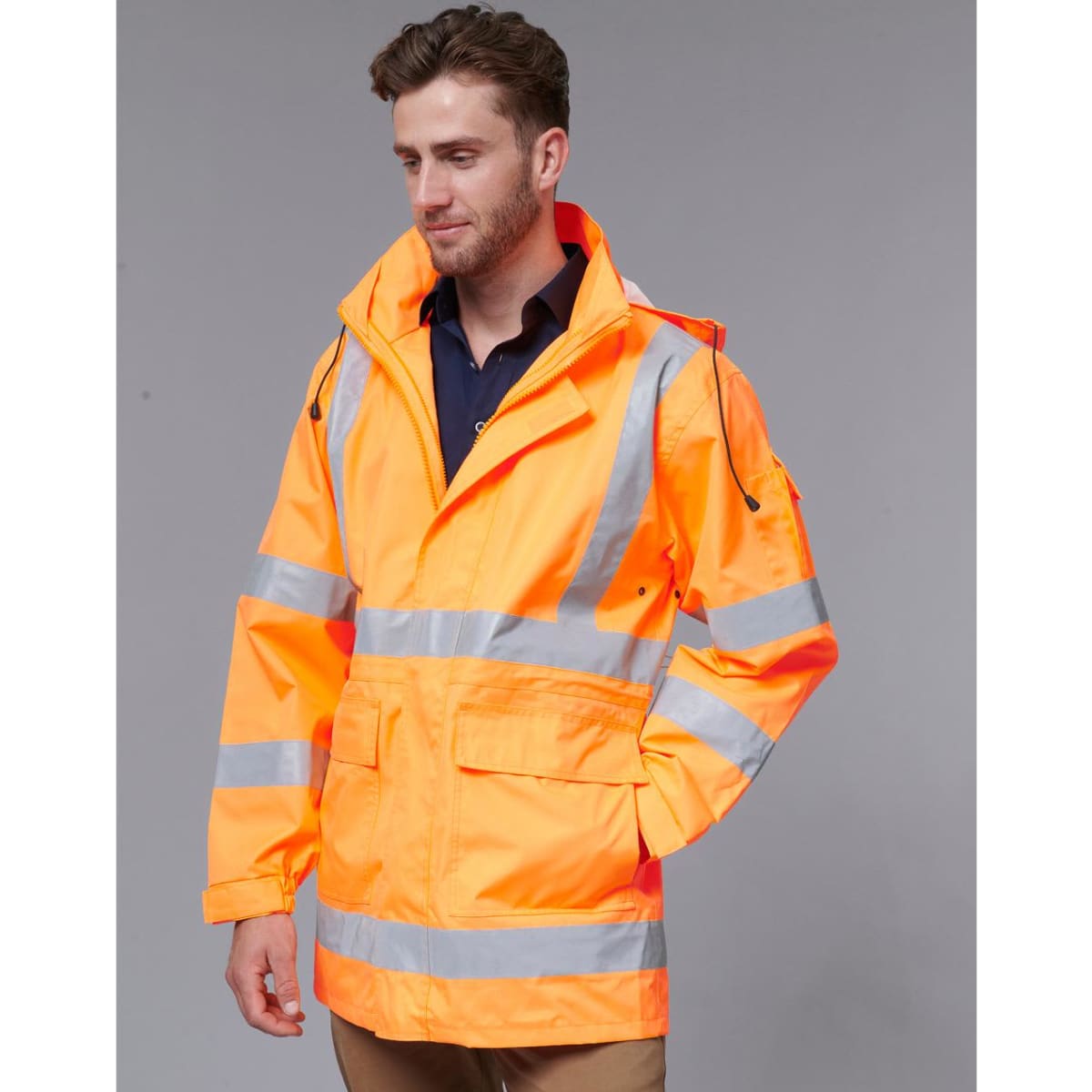 An orange safety jacket featuring reflective stripes, an adjustable hood, and multiple pockets. It has a logo on it.