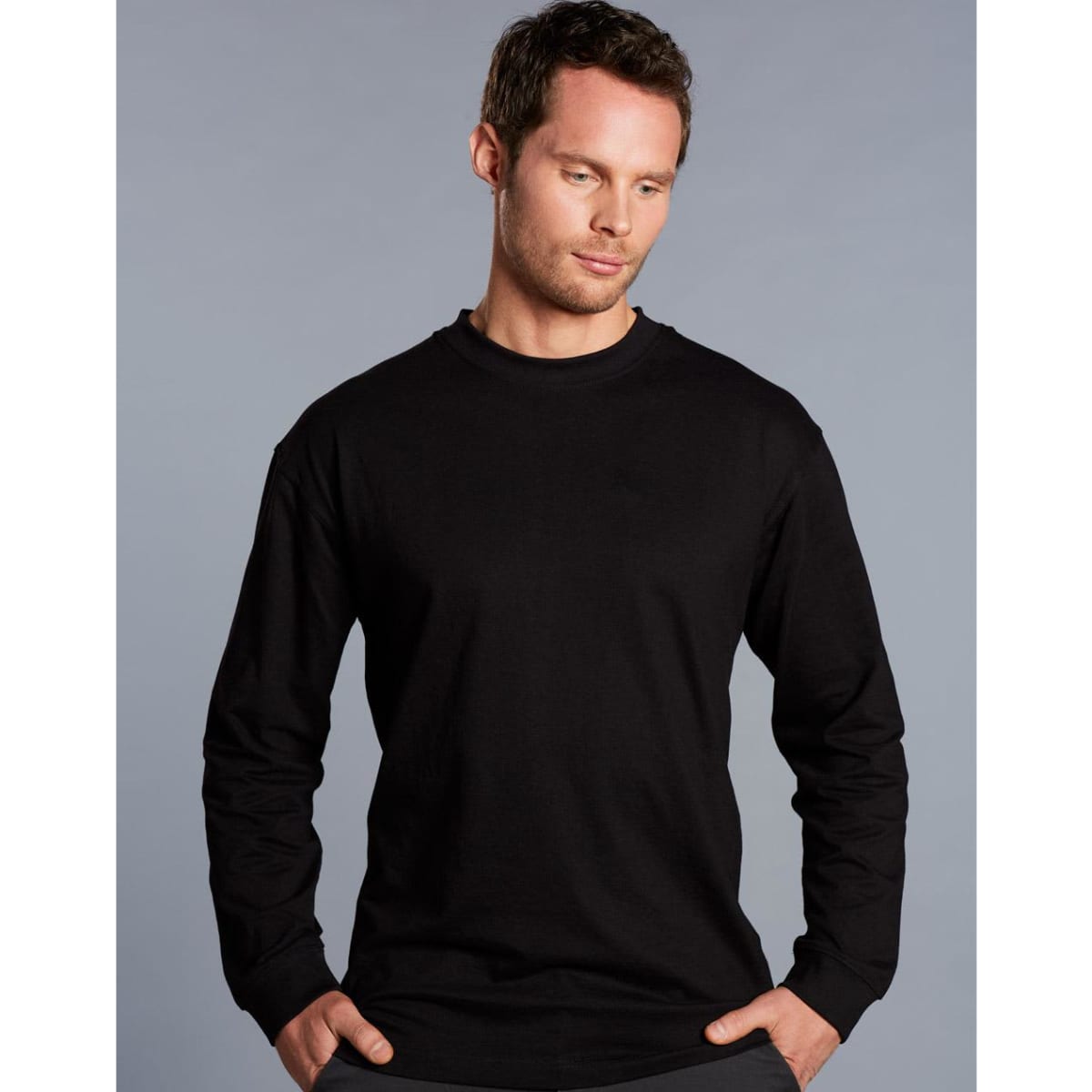 A black men's long sleeve crew neck T-shirt displayed on a model against a grey background. It has a subtle logo.