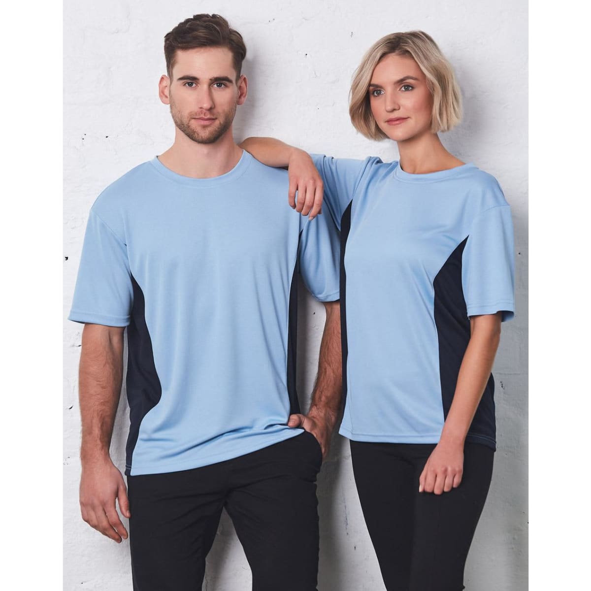 A light blue short sleeve contrast tee featuring navy side panels, displayed by two models against a white background.