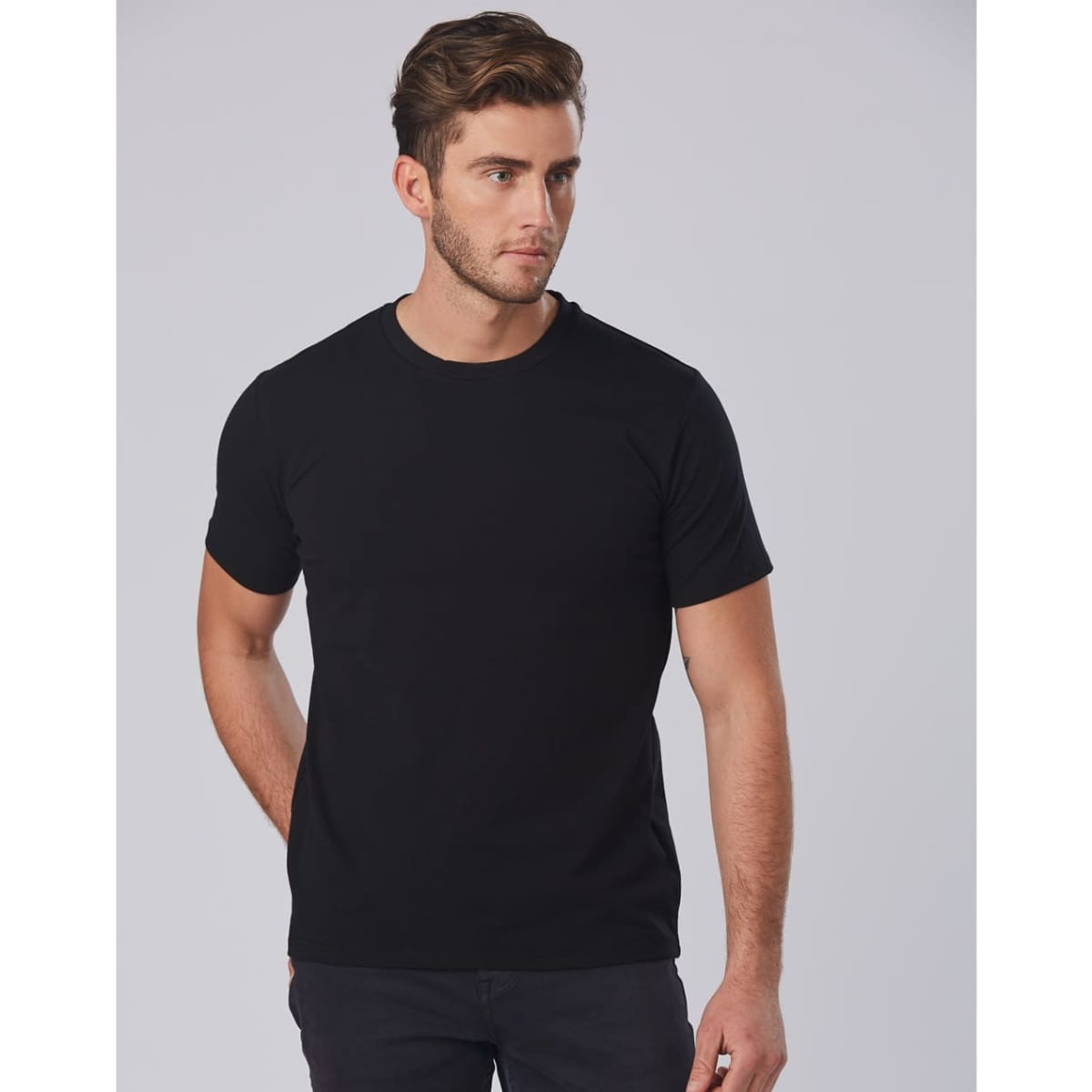 A fitted black stretch tee for men with a crew neck and short sleeves, featuring a logo.