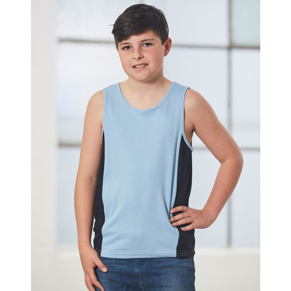 A kid's singlet in light blue with black side panels, featuring a logo. Ideal for casual wear.