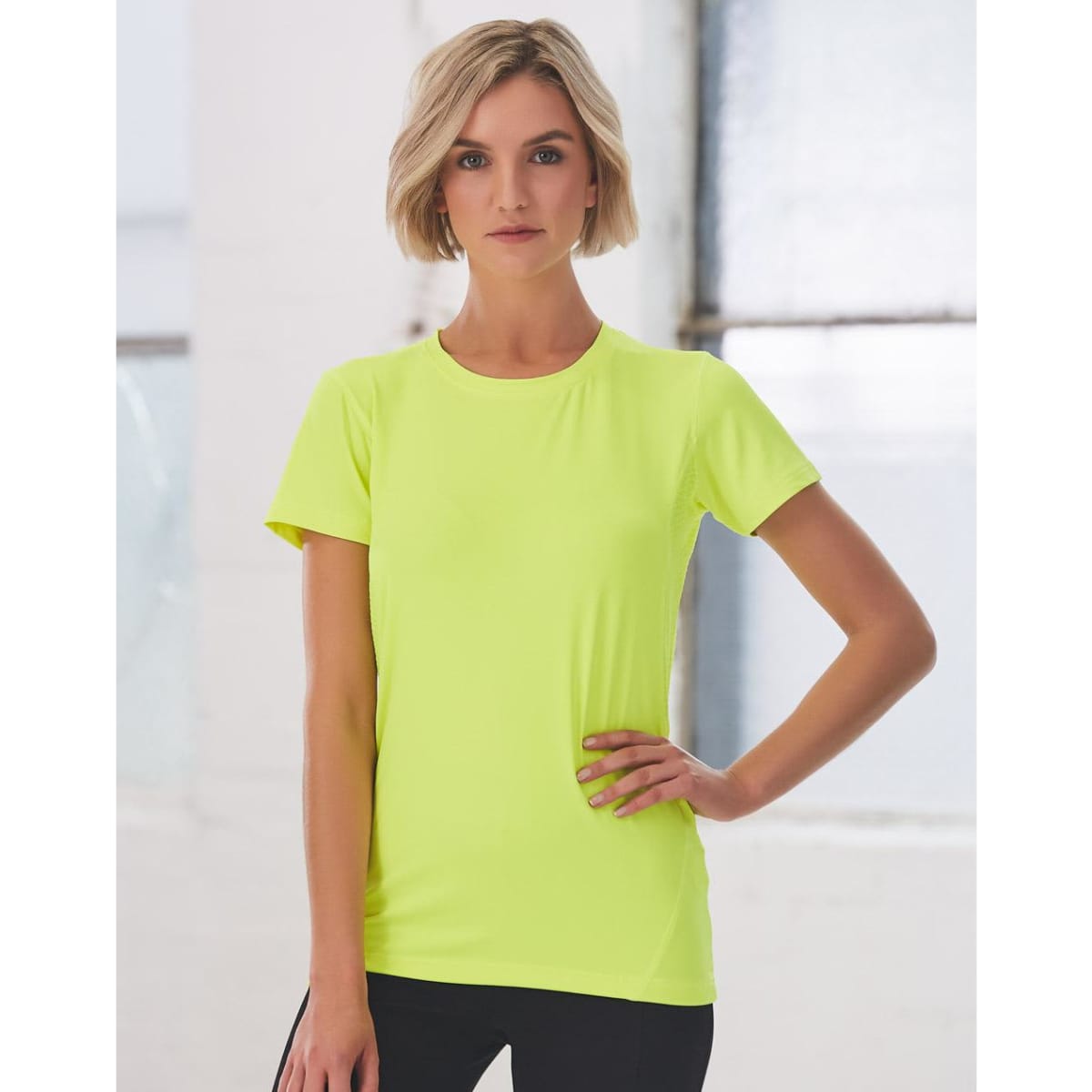 A fitted ladies' t-shirt in bright yellow, featuring short sleeves and a subtle logo.