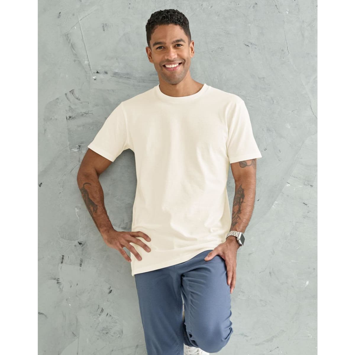A black premium cotton t-shirt displayed on a model, featuring short sleeves and a round neckline.