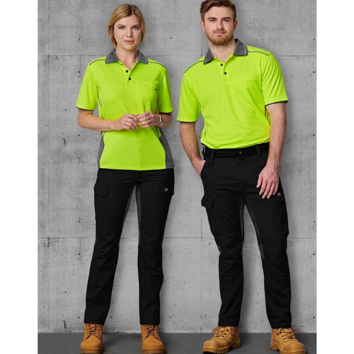 A pair of models wears bright green and grey work shirts with black rip-stop poly/cotton stretch work pants.