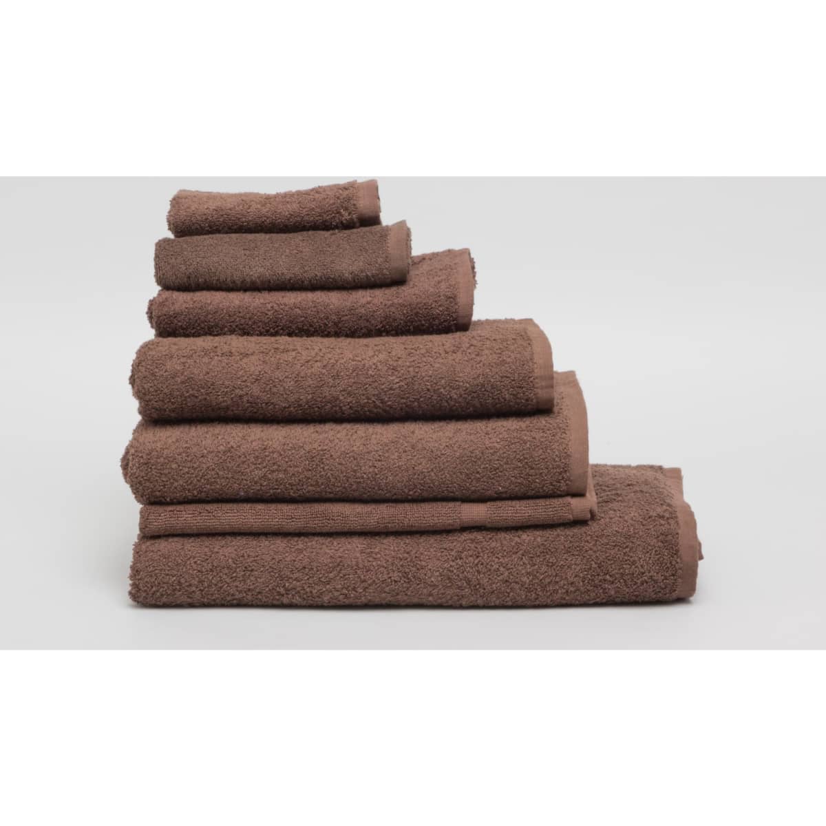 A stack of chocolate brown towels in various sizes with a textured finish, featuring a logo.