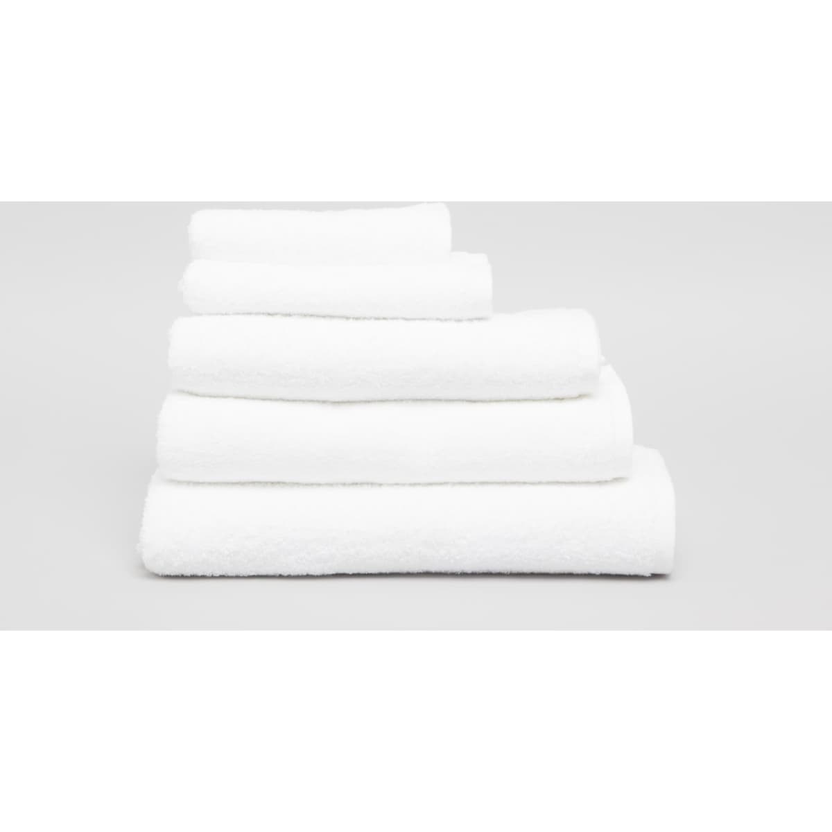 A stack of five white towels in varying sizes, showcasing their soft, fluffy texture. The image features a simple background.