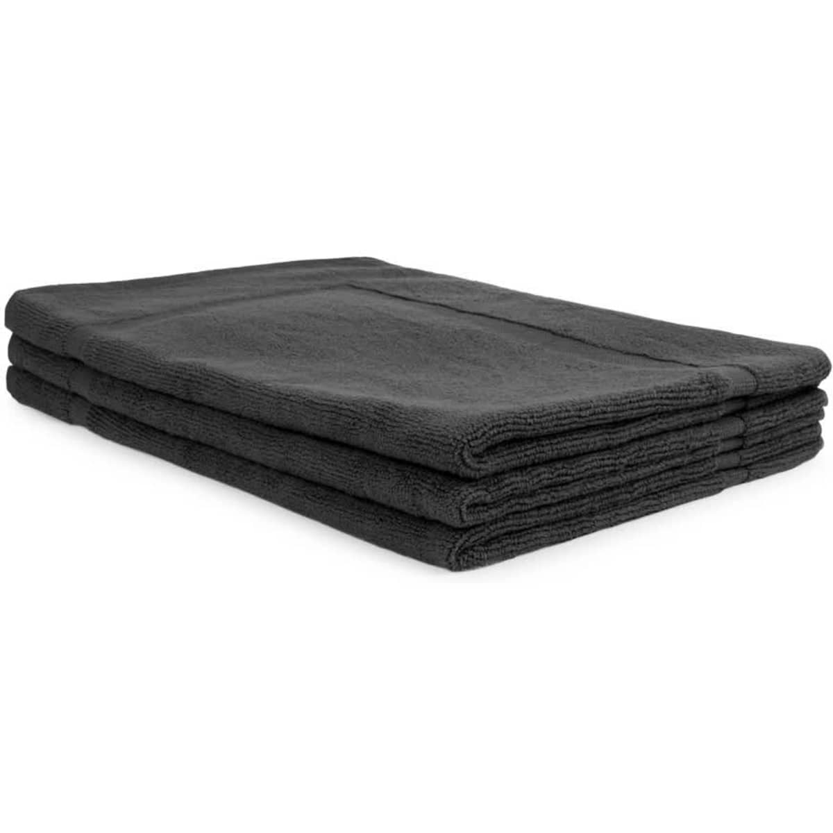 A stack of three dark grey bath mats made from 500 gsm material, featuring a textured surface and folded edges.
