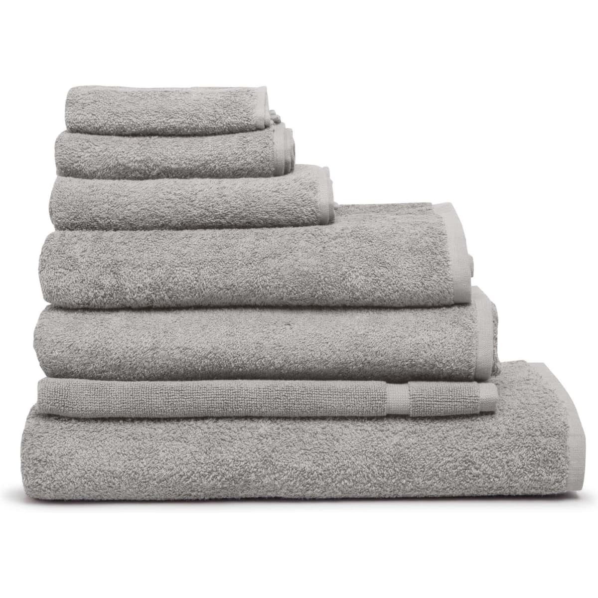 A stack of grey bath mats in varying sizes, featuring a soft texture and a simple design.
