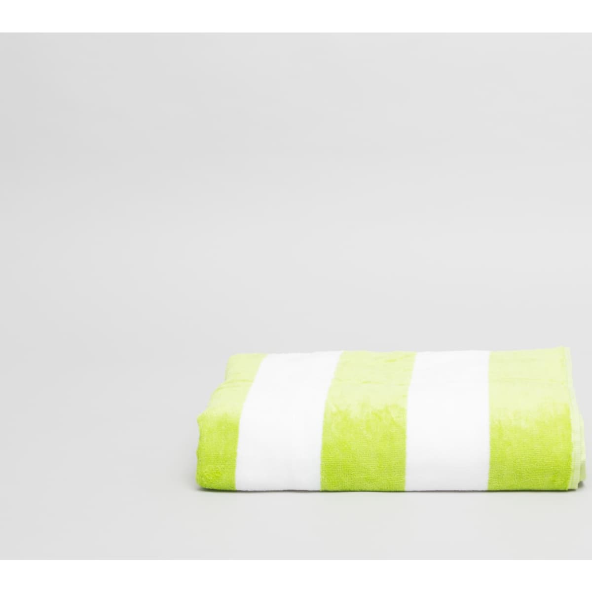 A folded beach towel with green and white stripes, featuring a logo on one side.