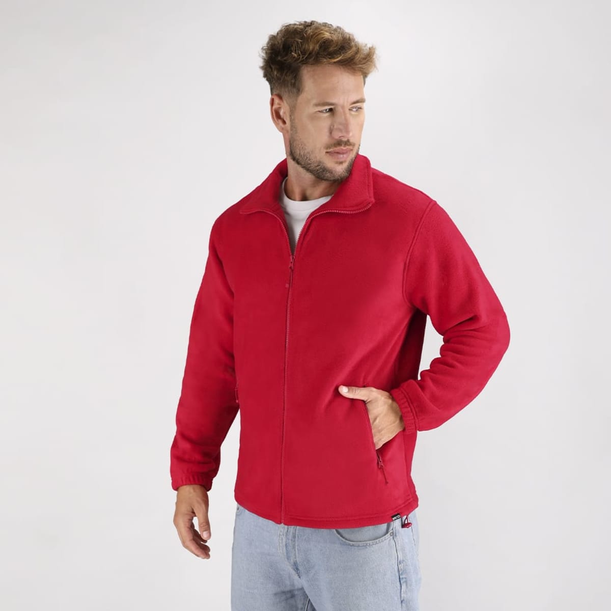 A red polar fleece jacket with a zip front and side pockets, featuring a logo on the left side.