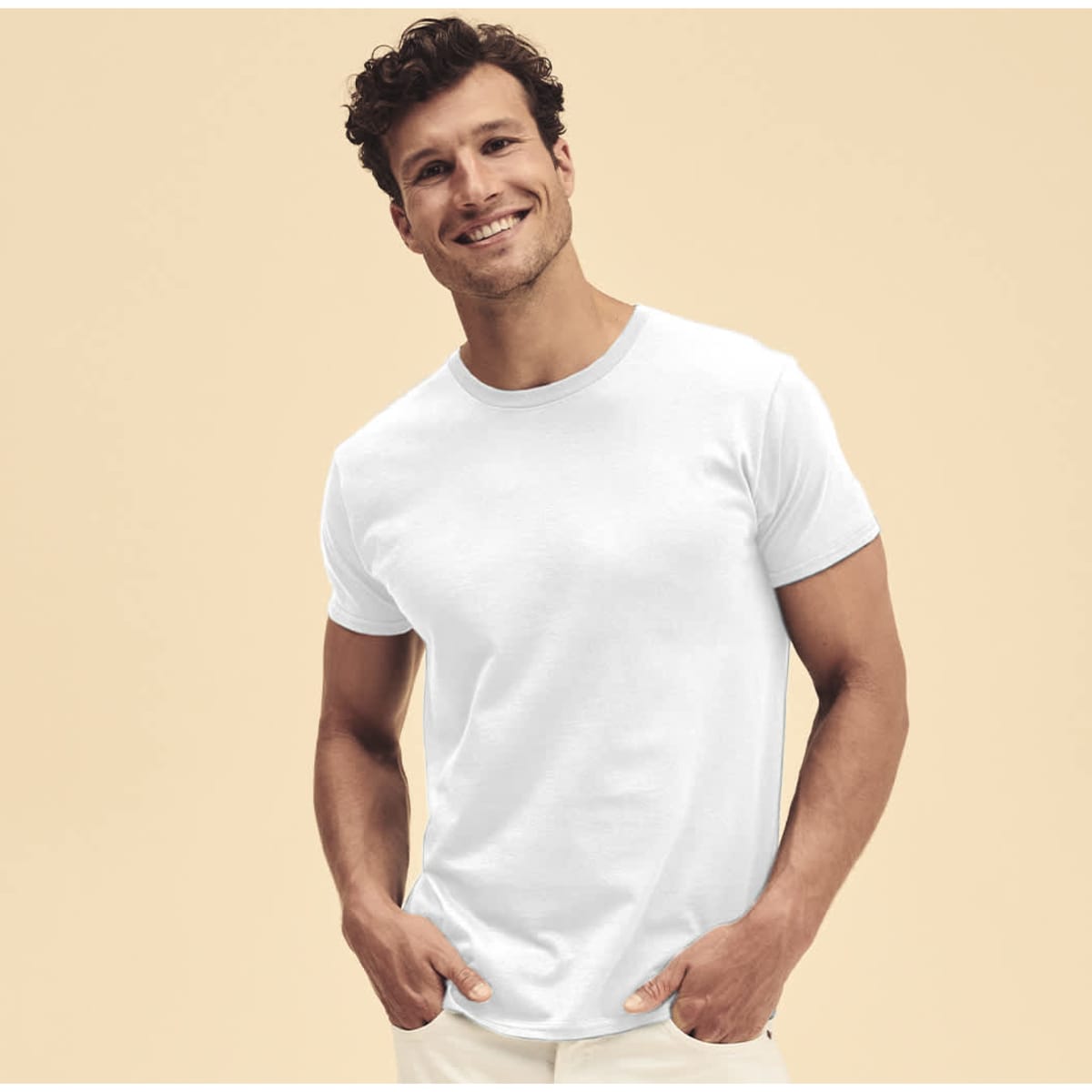 A white T-shirt worn by a smiling man with short curly hair, set against a neutral background.