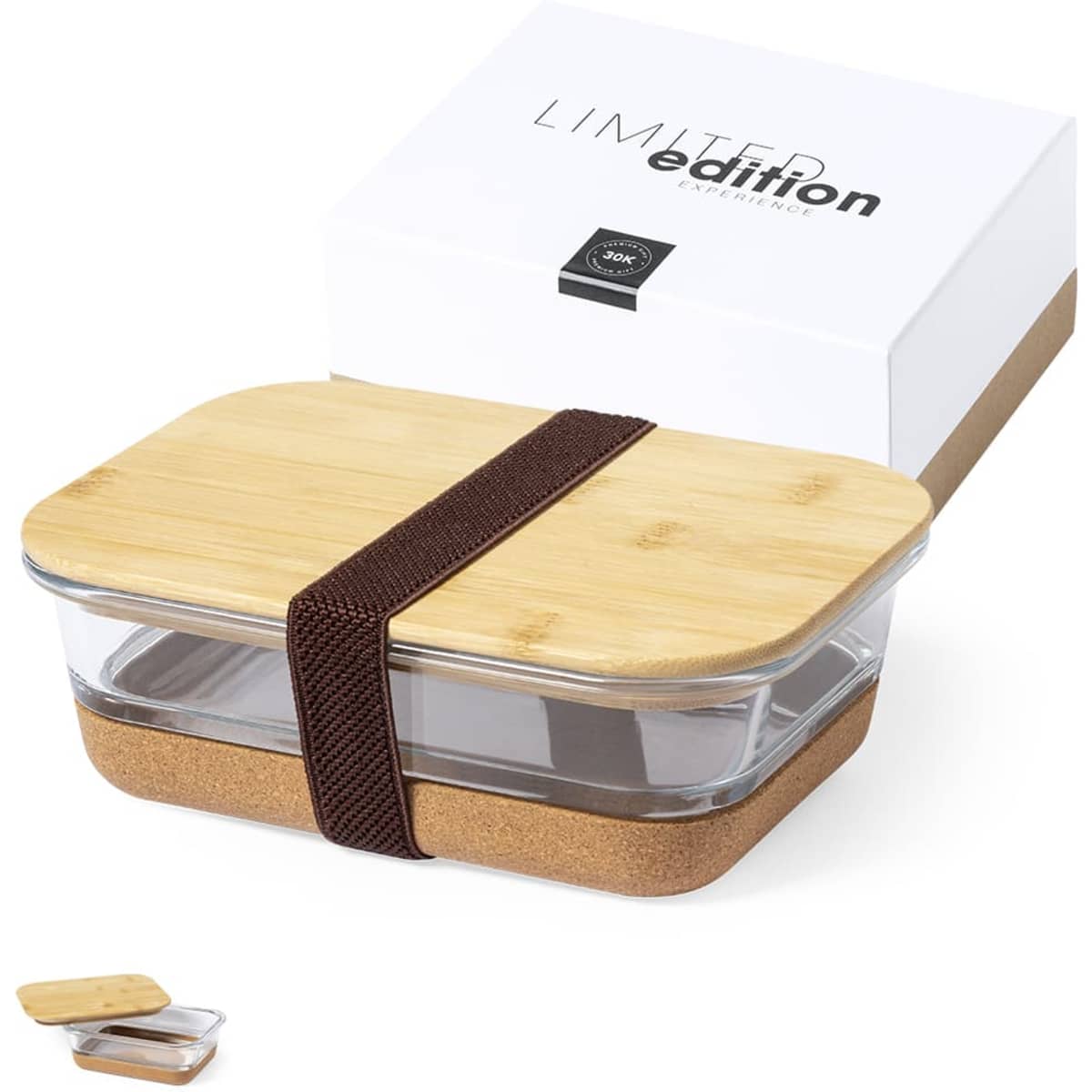 A glass lunch box with a bamboo lid and a cork base, secured with a brown elastic strap, packaged in a box.