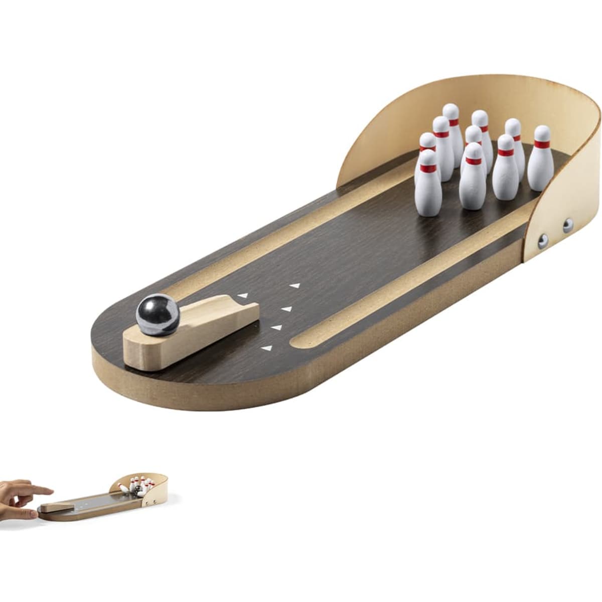A miniature bowling game featuring a wooden lane, pins in white with red bands, and a black bowling ball.
