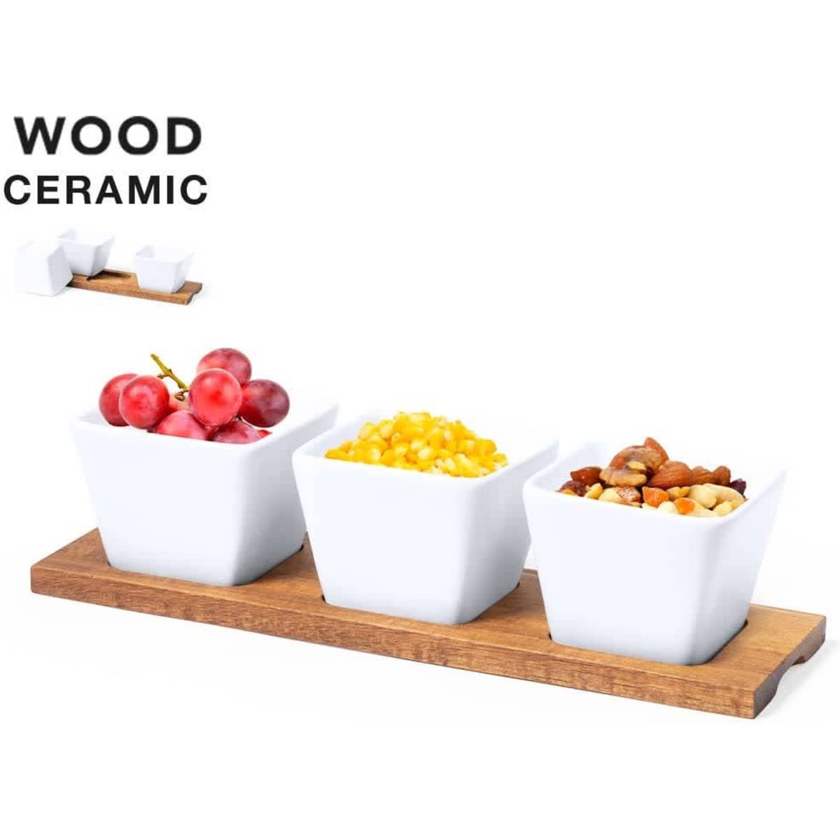 Three white ceramic serving dishes on a wooden tray, holding grapes, corn, and mixed nuts.
