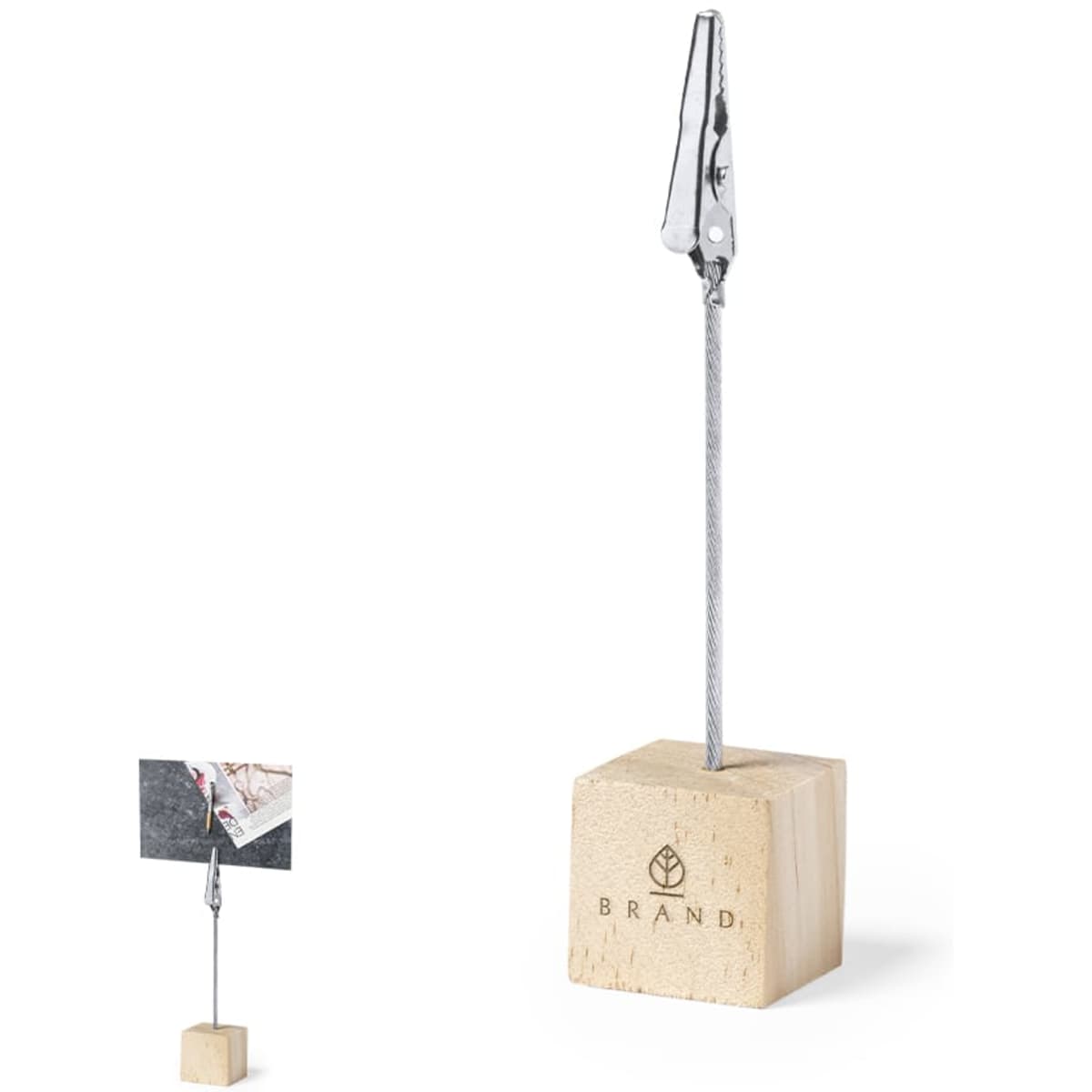 A clip holder with a metallic clip on a wooden base. The holder features a logo on the base.