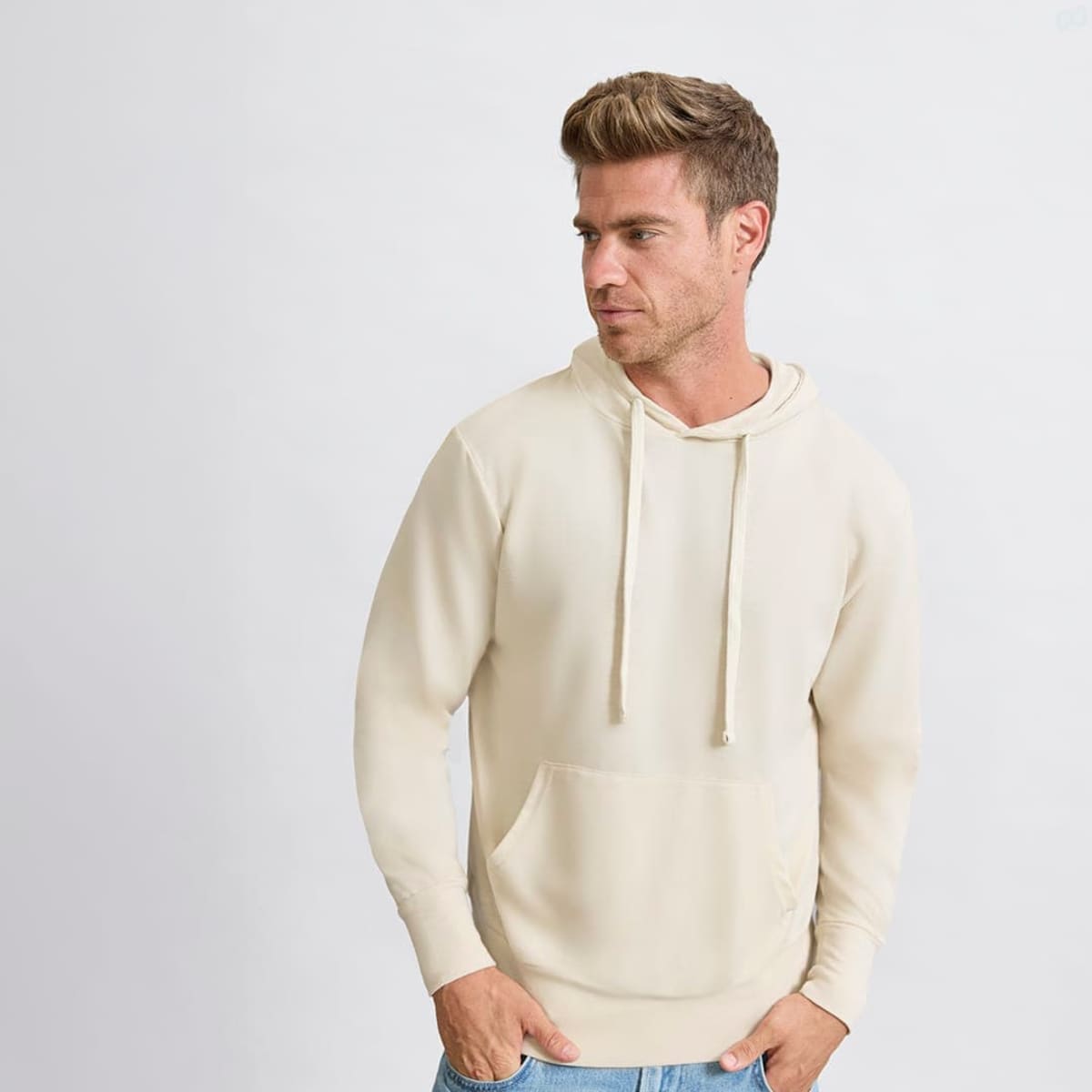 A beige hoodie with a kangaroo pocket and drawstring hood, featuring a small logo on the front.