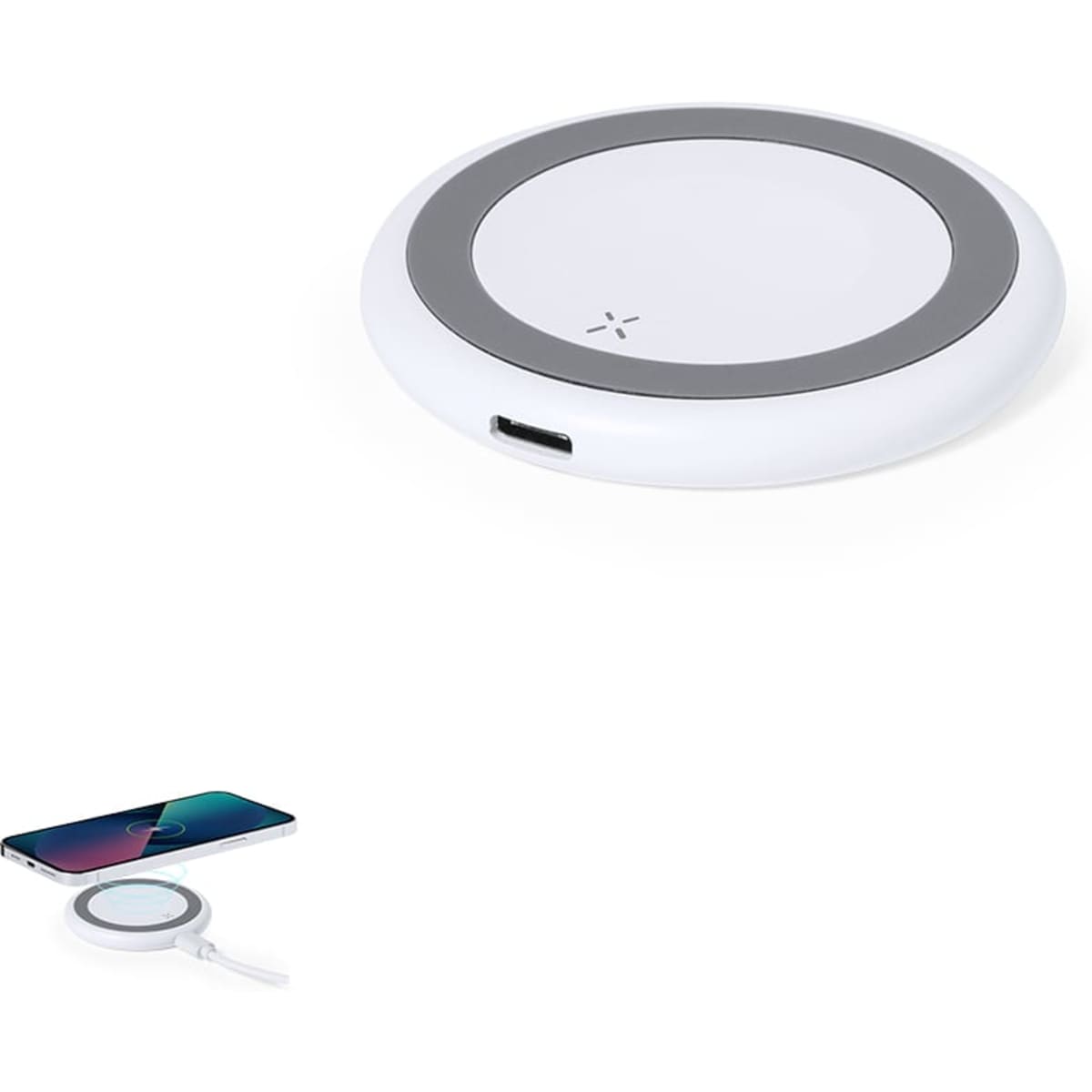A white wireless charger with a grey circular rim and a USB port, accompanied by a smartphone.