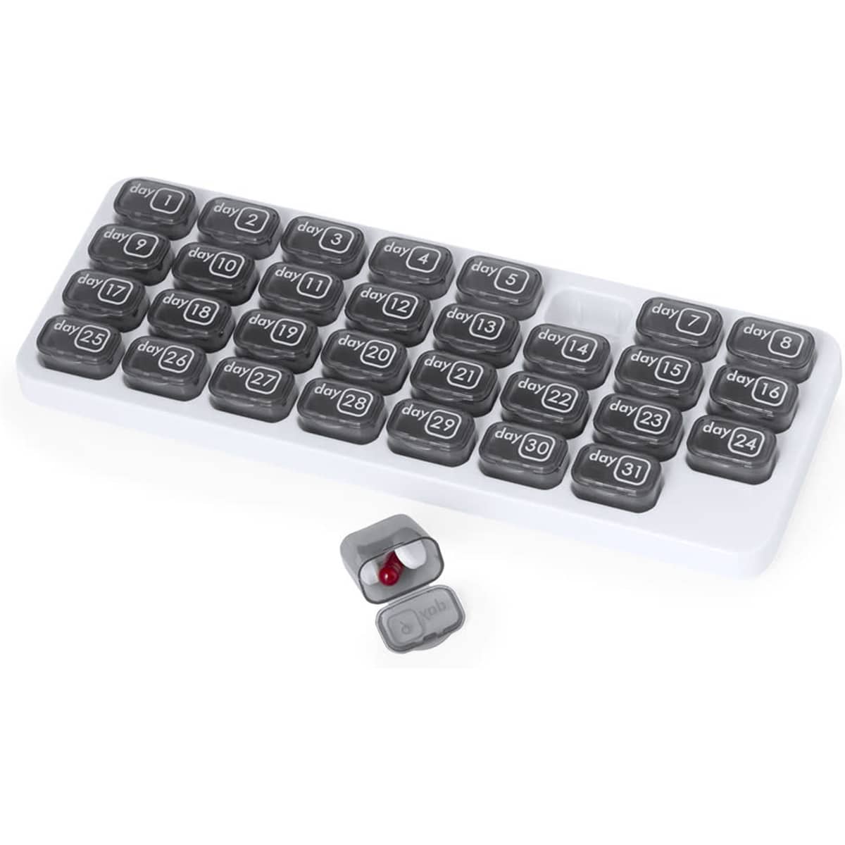 A pill organiser with grey compartments, labelled from day 1 to day 31, in a white tray. One compartment is open with a red capsule.