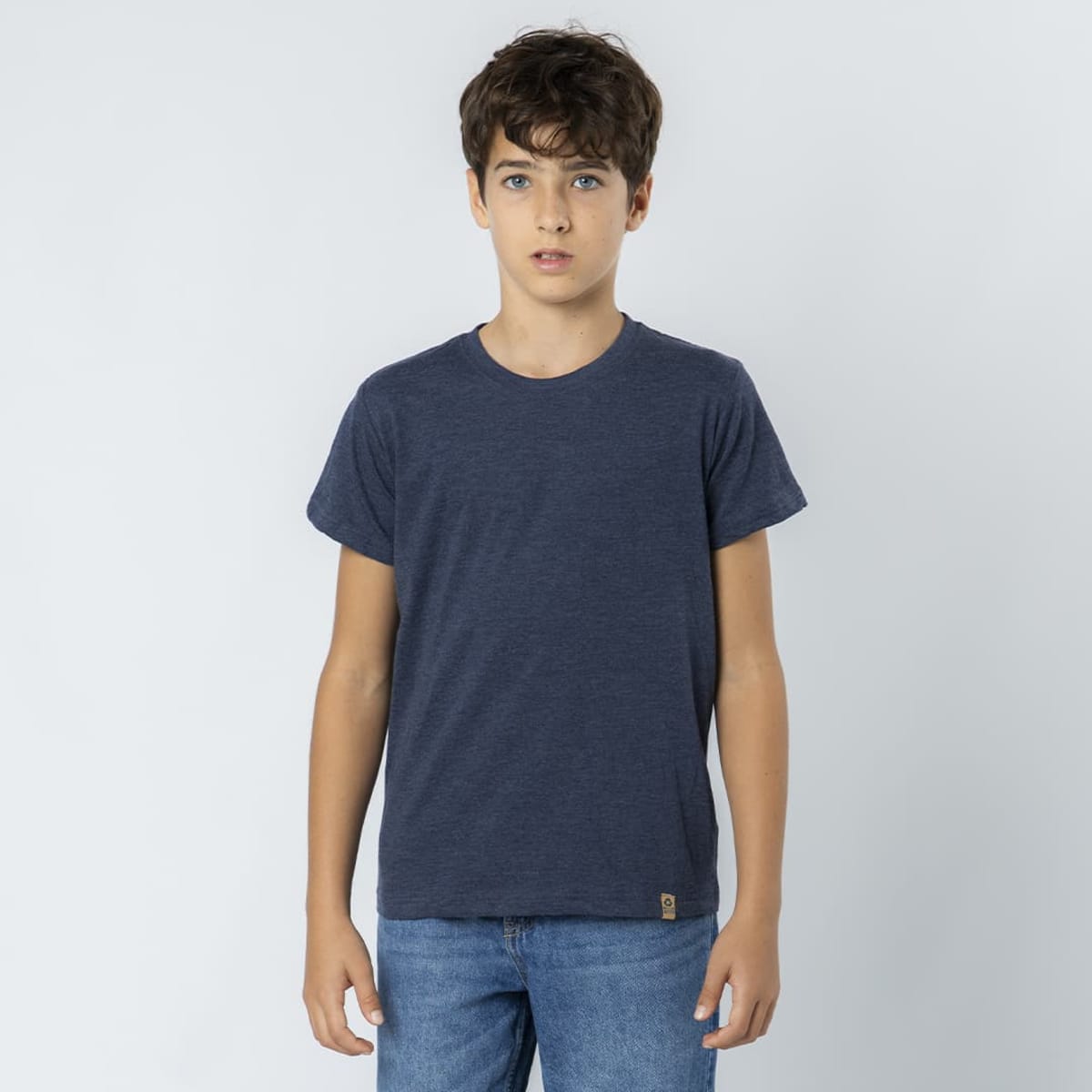 A navy-blue T-shirt for kids, featuring short sleeves and a logo on the hem, paired with denim jeans.