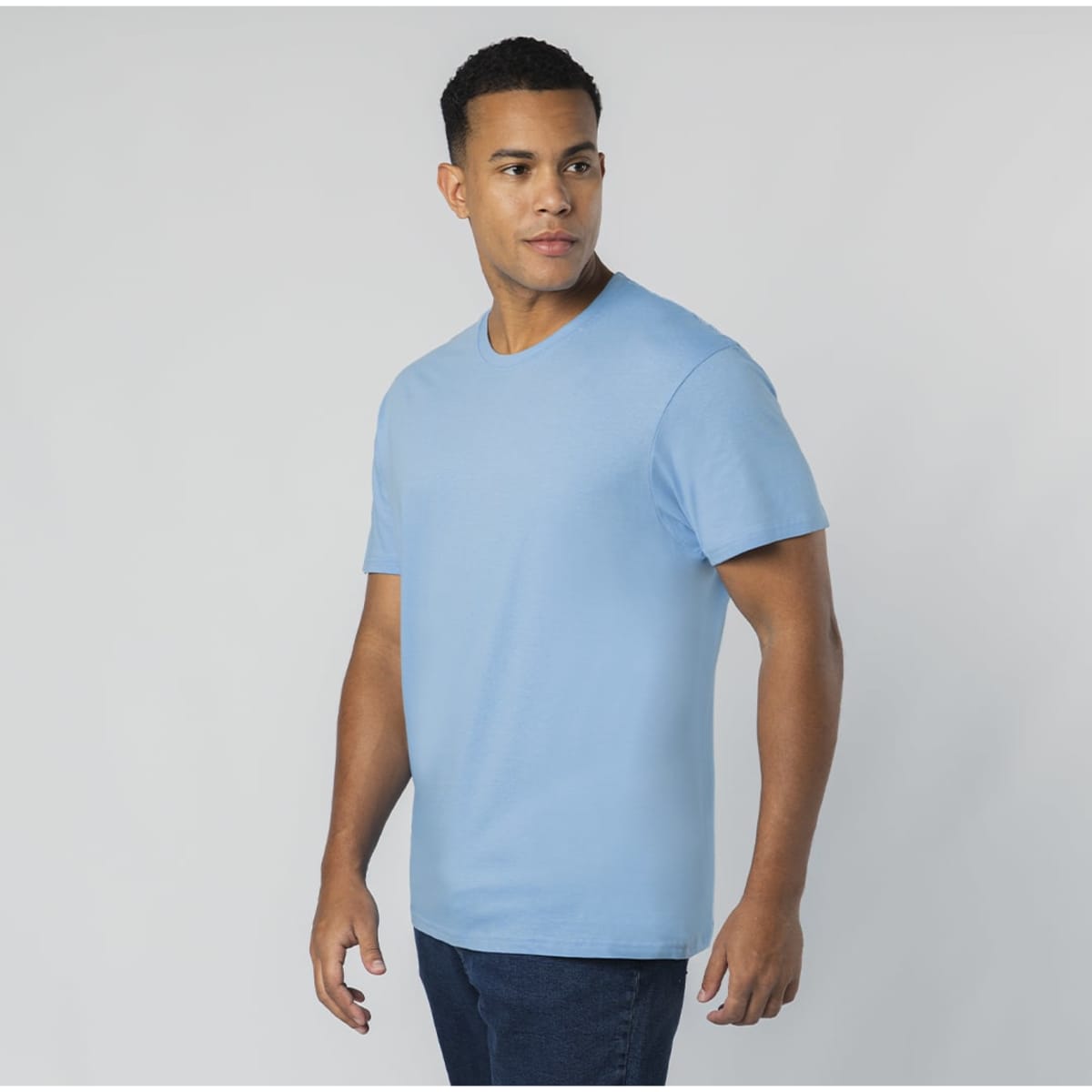 A blue T-shirt worn by a model, featuring a crew neckline and short sleeves. The shirt has a logo on it.