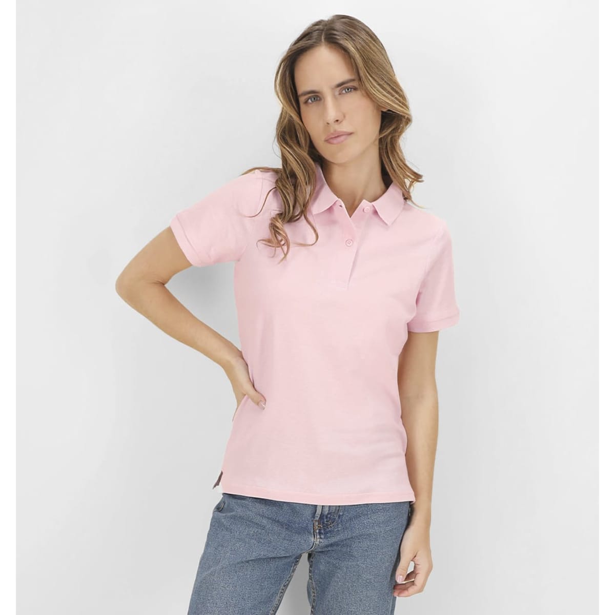 A pink polo shirt with a collar, featuring a logo, worn by a model against a plain background.