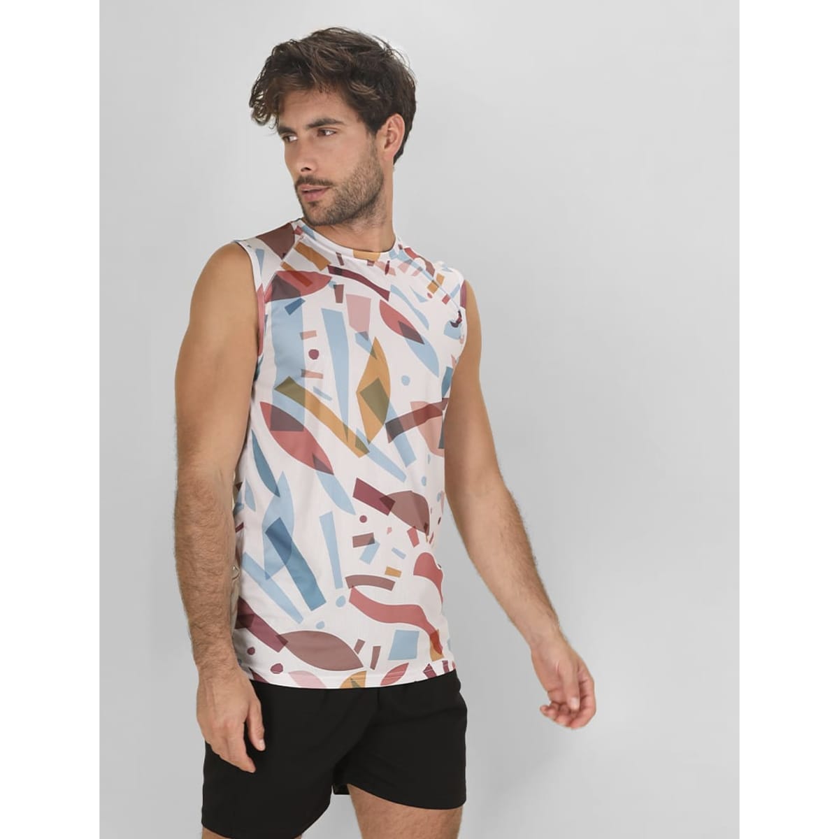 A sleeveless Katsu T-Shirt featuring an abstract multicoloured geometric pattern, paired with black shorts.