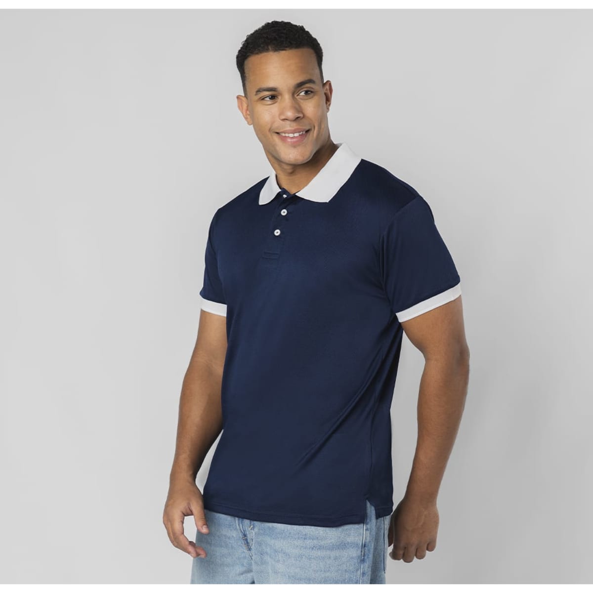 A navy polo shirt with a contrasting light-coloured collar and cuffs, featuring a logo.