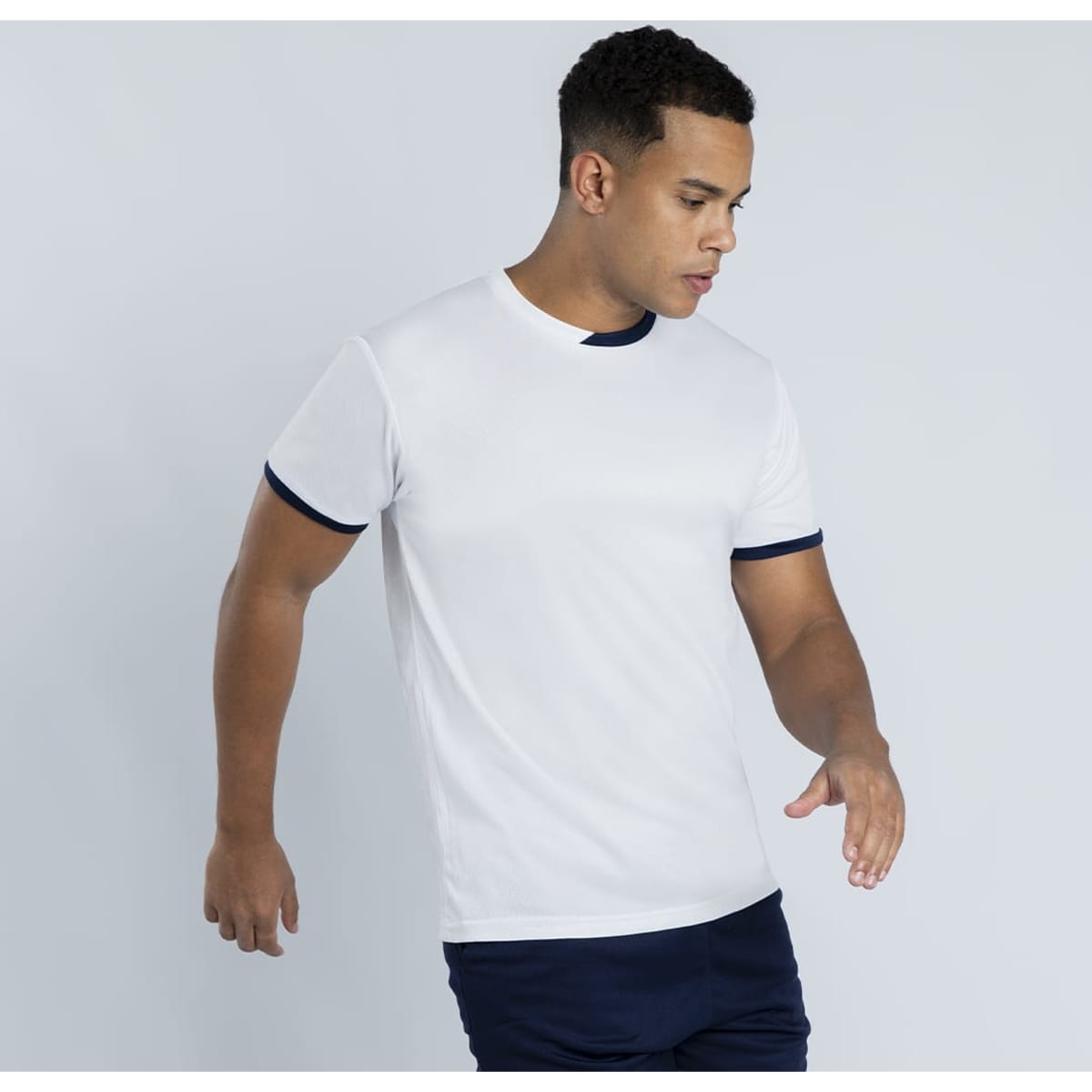 A white T-shirt with navy blue trim, featuring a logo on the chest and short sleeves.
