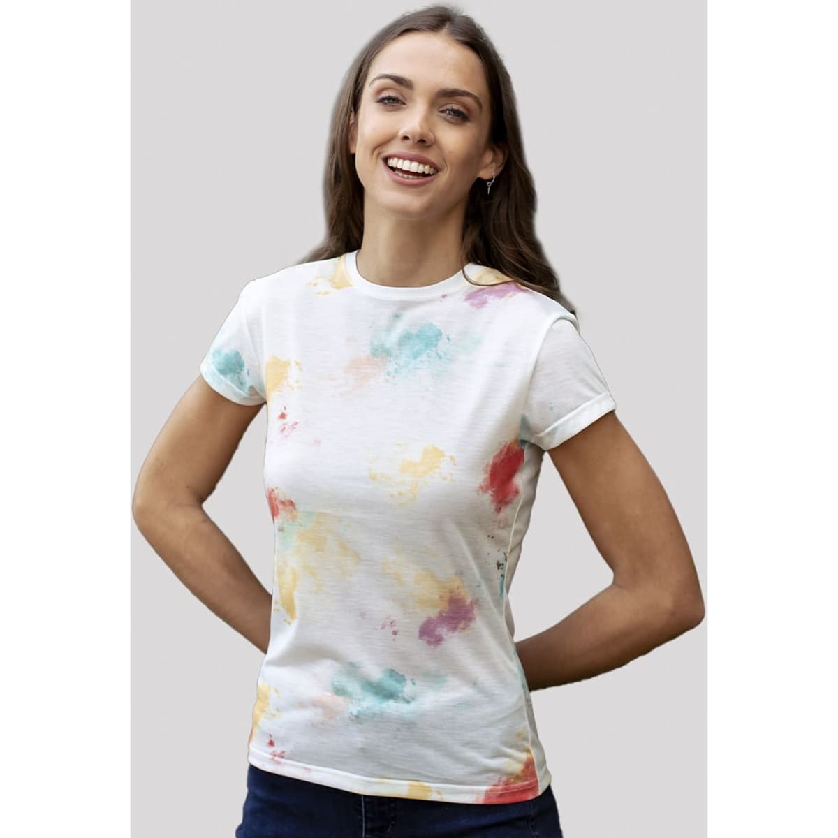 A white T-shirt featuring a colourful splatter design in shades of red, blue, and yellow. The shirt has a fitted silhouette.