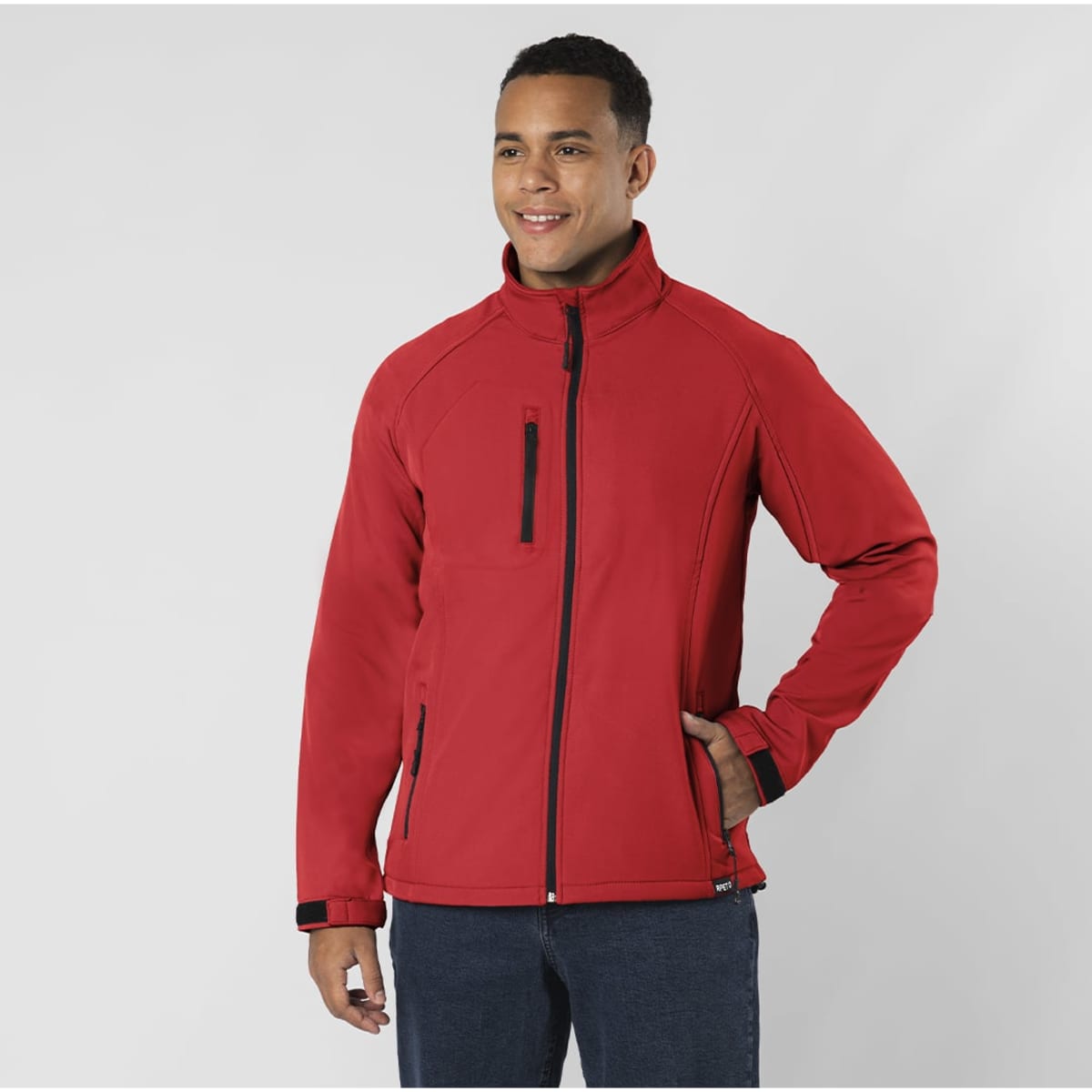 A red soft shell jacket featuring a zip front, side pockets, and a logo on the chest, showcased on a model.