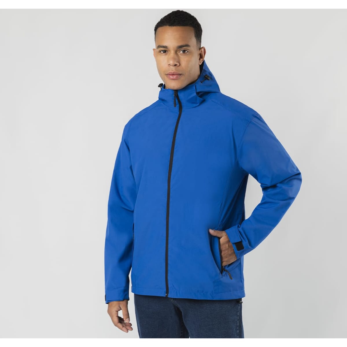 A blue rain jacket with a hood, featuring a zip front and a simple design. The jacket has a logo on it.