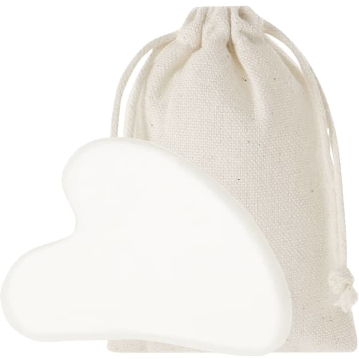 A heart-shaped massage tool in white, accompanied by a natural fabric pouch.