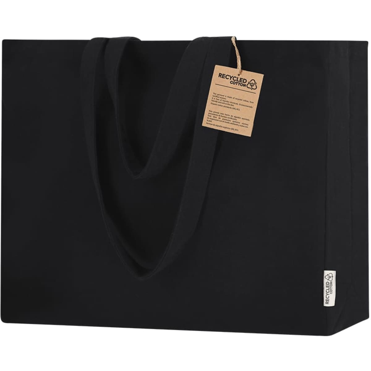 A black tote bag with two handles and a tag, made from recycled material, featuring a logo.