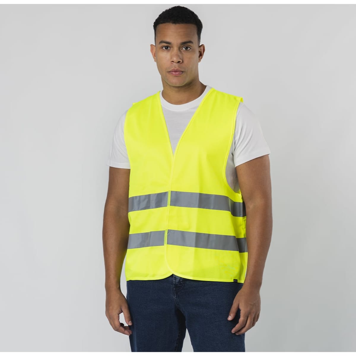 A high-visibility yellow safety vest with reflective grey strips, featuring a logo on the front.
