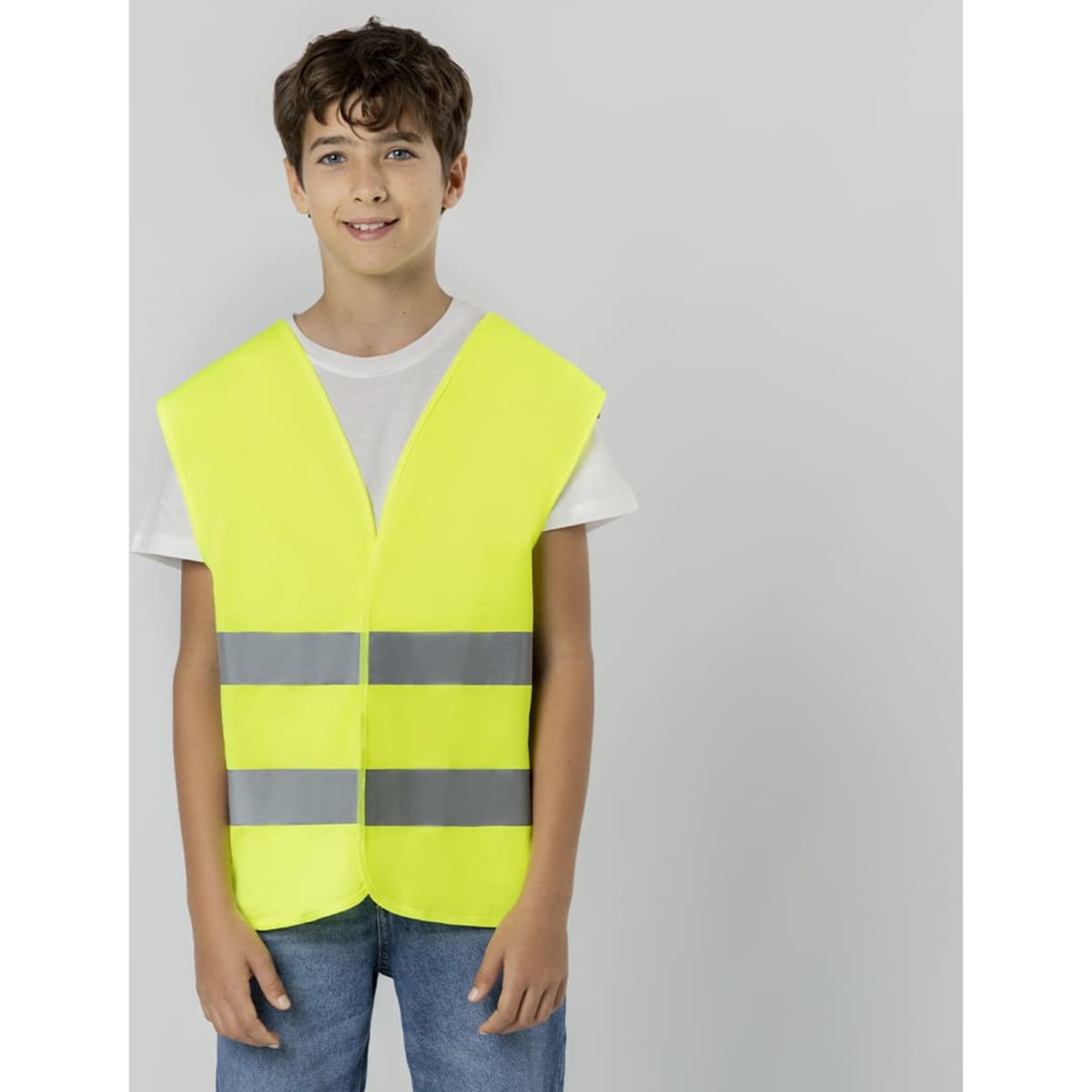 A yellow safety jacket featuring reflective strips, worn by a young person against a neutral background.
