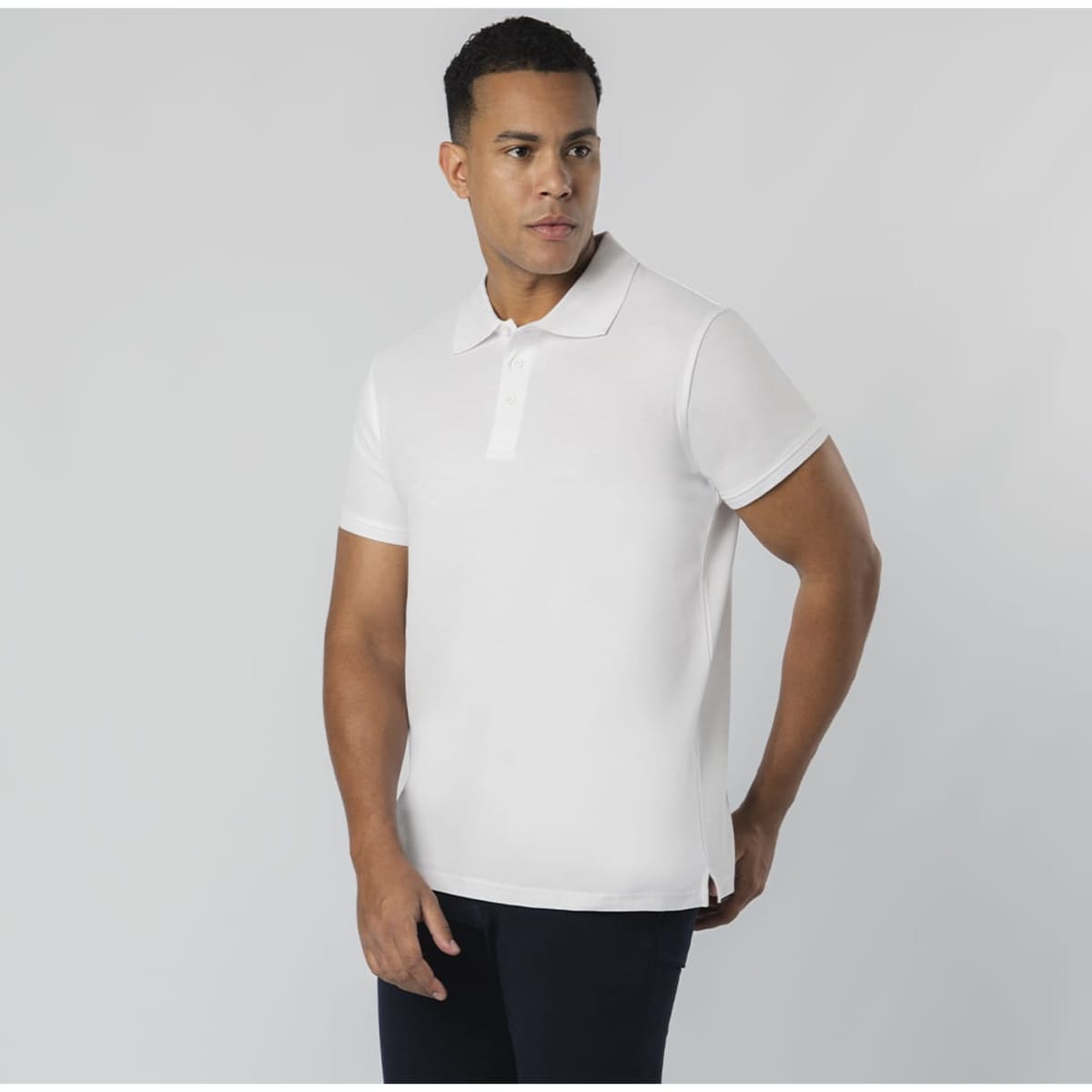 A white polo shirt with a collar and short sleeves, featuring a logo on the chest.