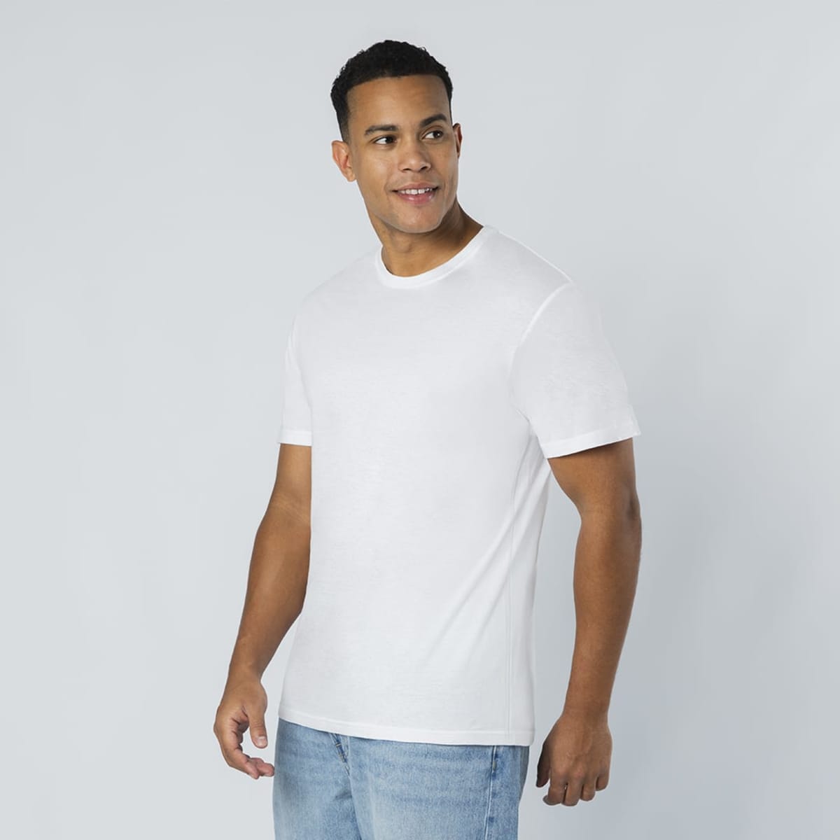 A white T-shirt with a classic crew neckline, shown on a model against a light background.