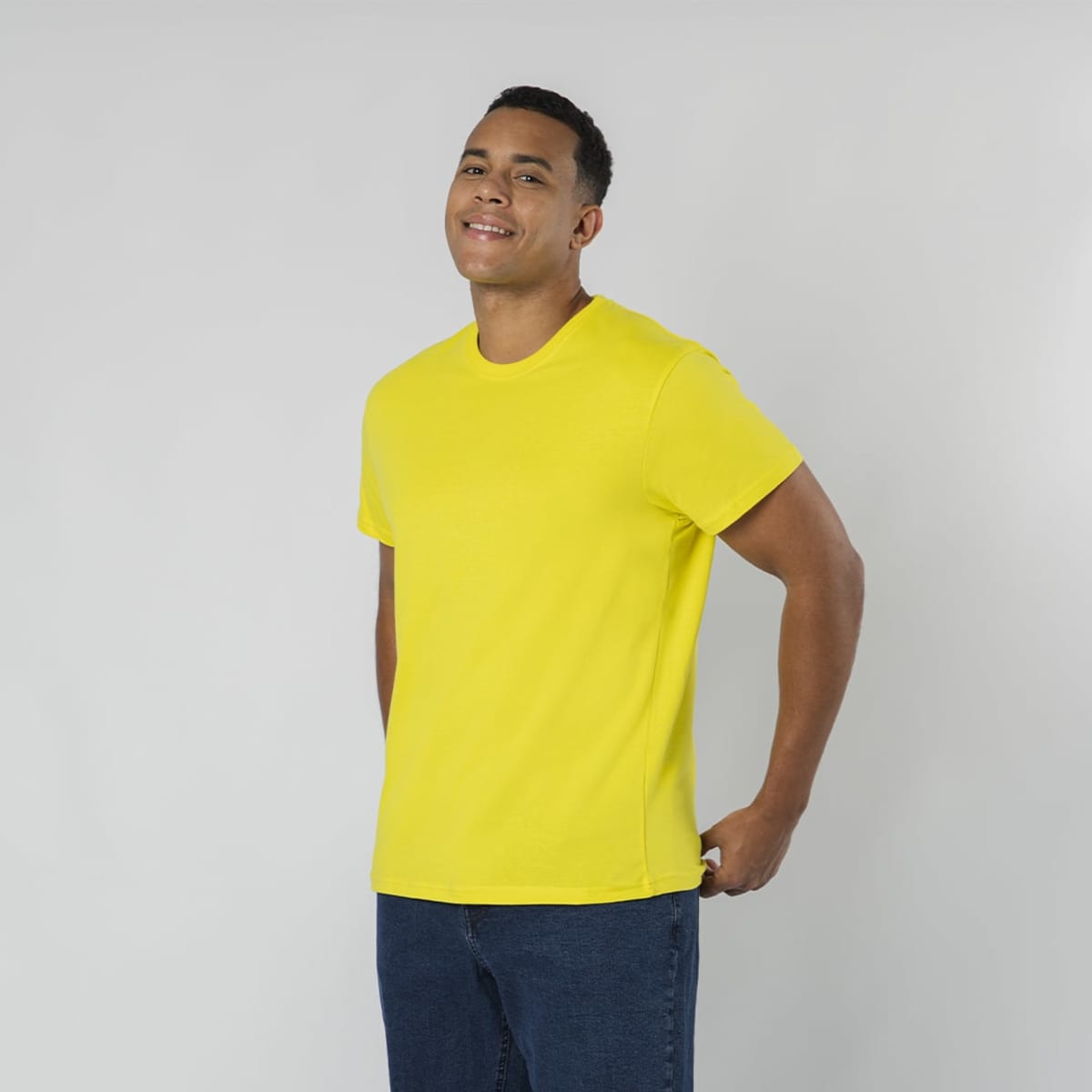 A bright yellow T-shirt on a smiling man, featuring short sleeves and a simple design.