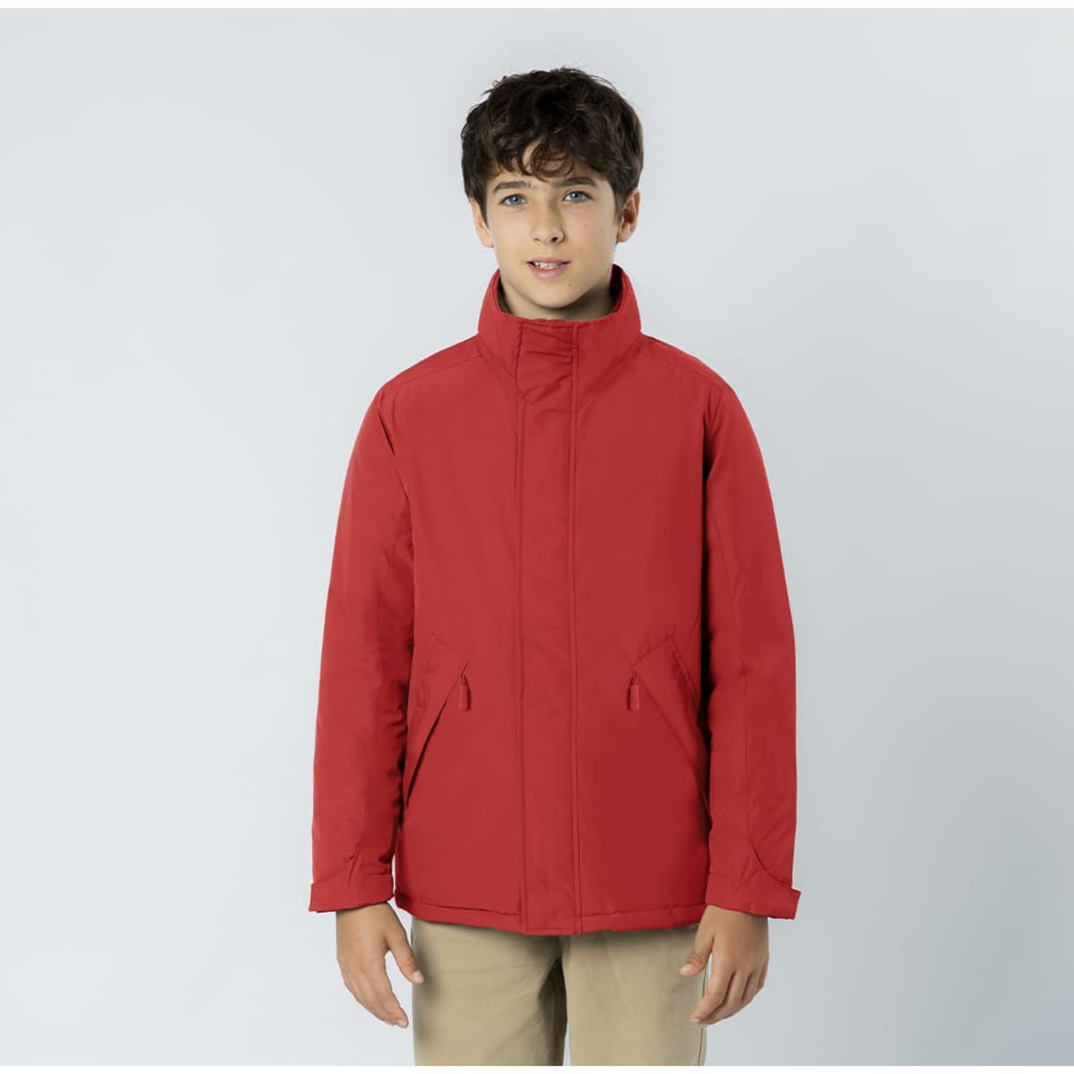 A red jacket featuring a high collar and side pockets, designed for children. It has a logo on it.