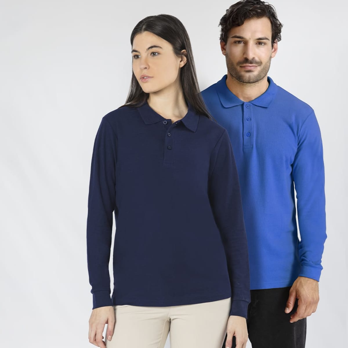 A navy long-sleeve polo shirt worn by a woman and a blue long-sleeve polo shirt worn by a man, both featuring logos.