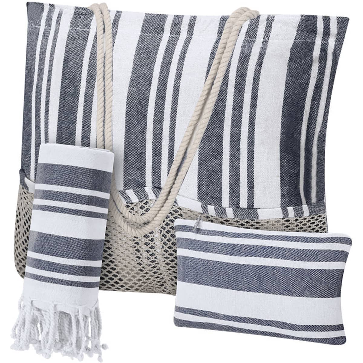 A striped beach tote in navy and white, with a mesh bottom, accompanied by a towel and a decorative cushion.