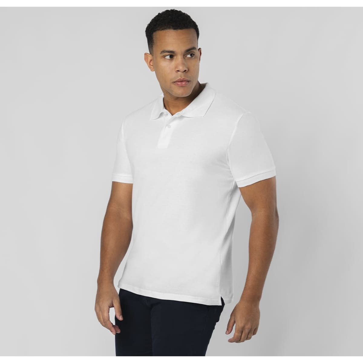 A white polo shirt displayed on a model, featuring a collar and short sleeves, with a logo on the chest.