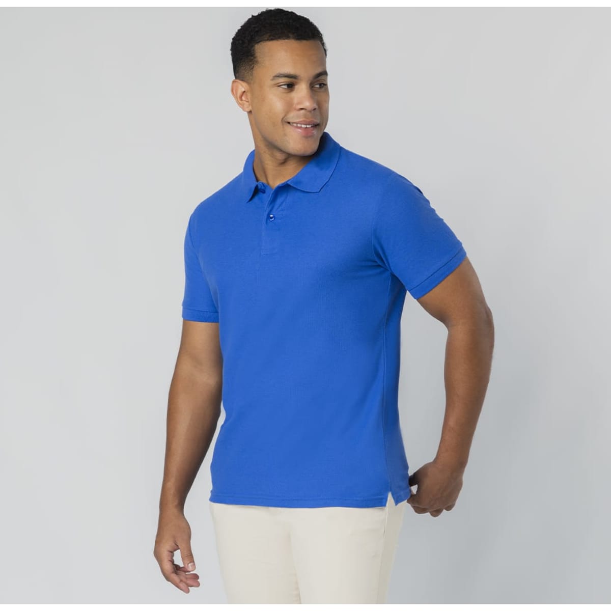 A blue polo shirt with a collar and short sleeves, featuring a logo. The model is casually posed.