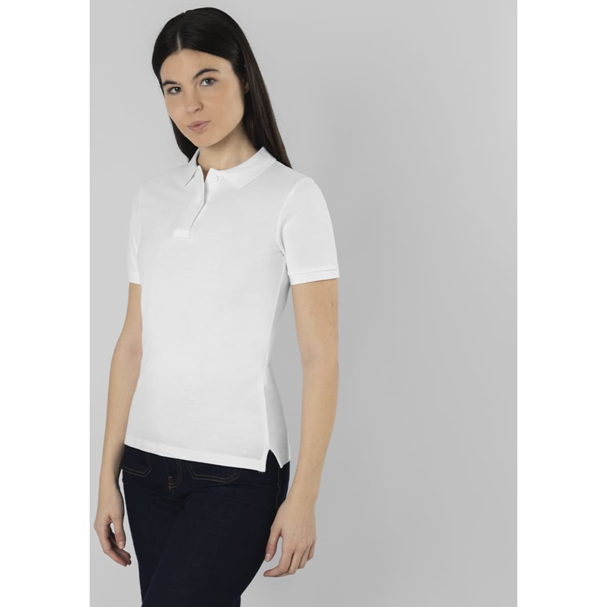 A fitted white polo shirt with short sleeves, featuring a collar and a logo, worn by a model.