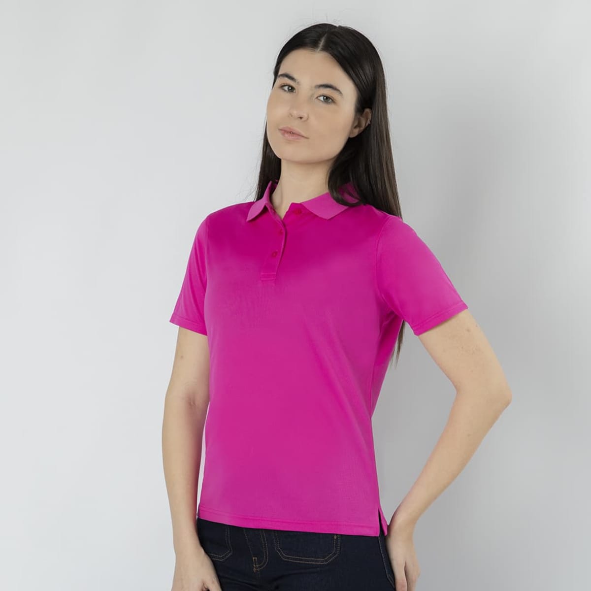 A pink Tecnic Plus polo shirt displayed on a model, featuring short sleeves and a collar, with a logo.