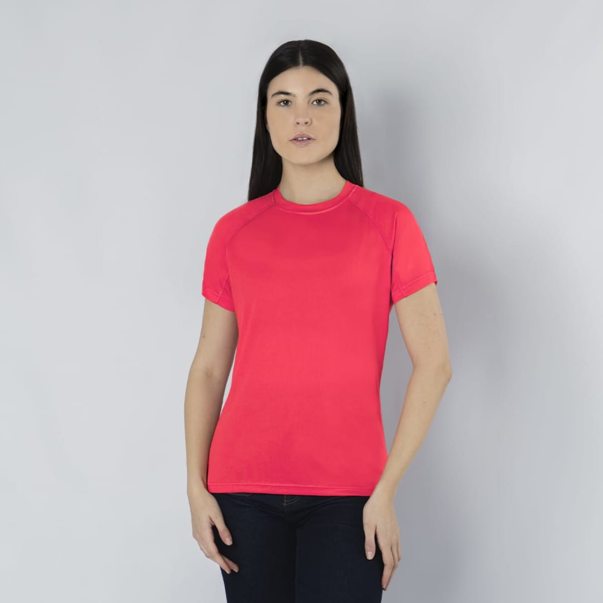 A pink Cocker T-Shirt displayed on a model with long dark hair, set against a grey background.